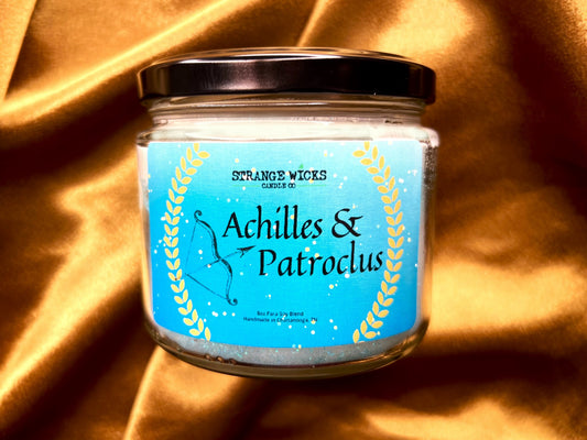 Close-up of Achilles and Patroclus candle label with laurel wreath and bow art