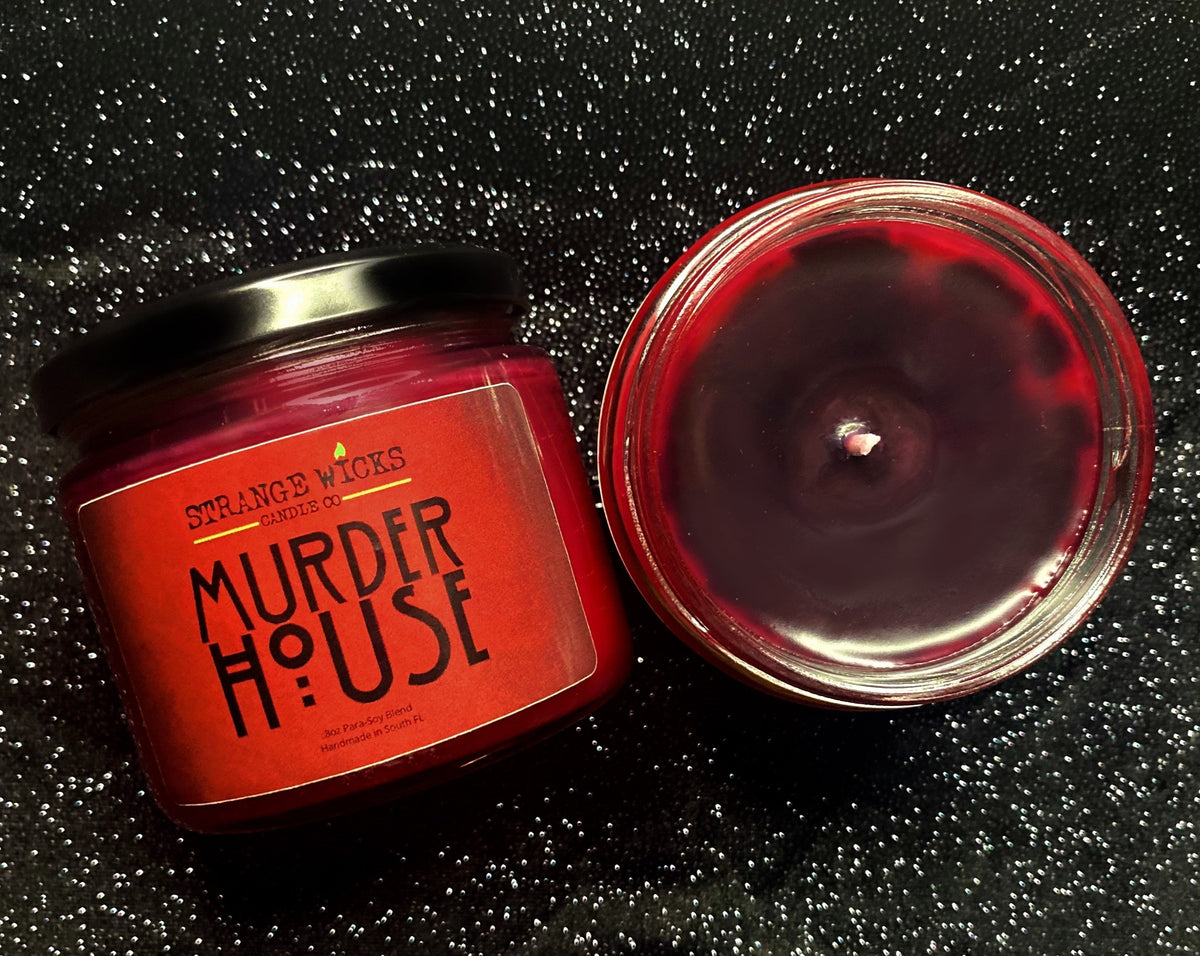 Murder House – AHS Candle – red jar with black label beside open dark-red wax