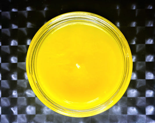 Top-down view of open Hiya, Georgie candle showing smooth yellow wax