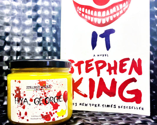 Hiya, Georgie candle posed beside the Stephen King IT novel