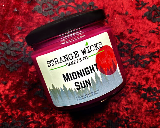 Closed Midnight Sun candle jar with black lid on red lace fabric