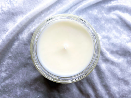 Top-down view of Schmidt Happens – New Girl Candle showing smooth white wax and wick