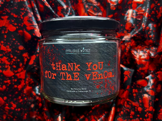 Close-up of the Thank You for the Venom candle label in red typewriter font