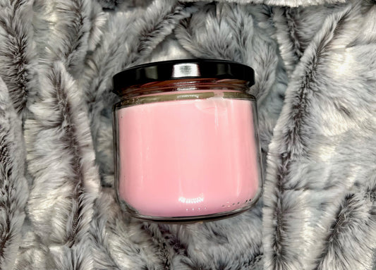 Little Women candle jar with black lid showing pink wax through glass