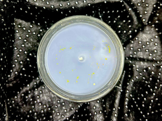 Top view of Xaden candle, pale wax with gold glitter flecks and centered wick