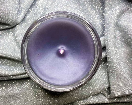 Top-down view of Nesta candle showing purple wax and centered wick