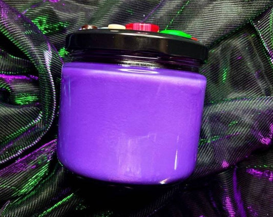 Side view of Other Mother purple candle jar with button-topped black lid
