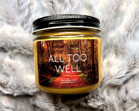 All Too Well Candle label close-up on amber jar with black lid