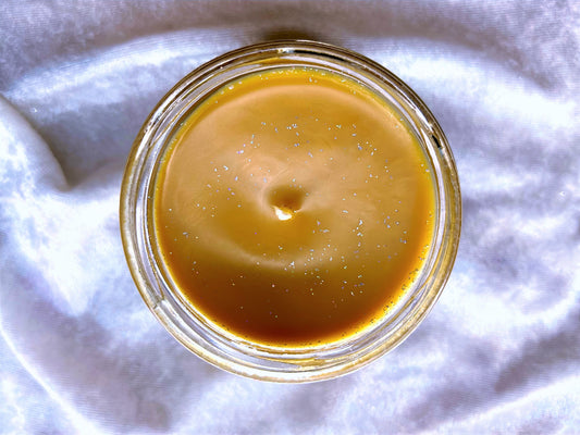Top-down view of Autumn Court – ACOTAR Candle showing golden glitter wax surface and wick