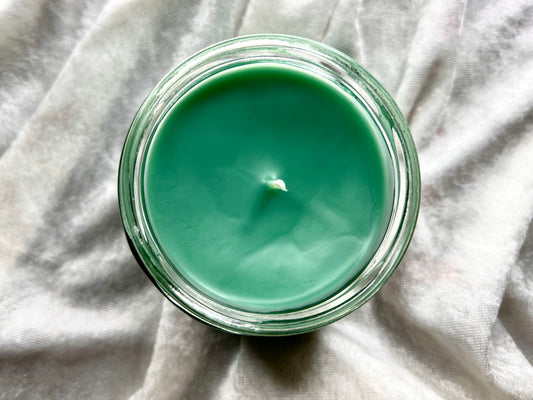 Top-down view of Believe Bigfoot candle's green wax surface
