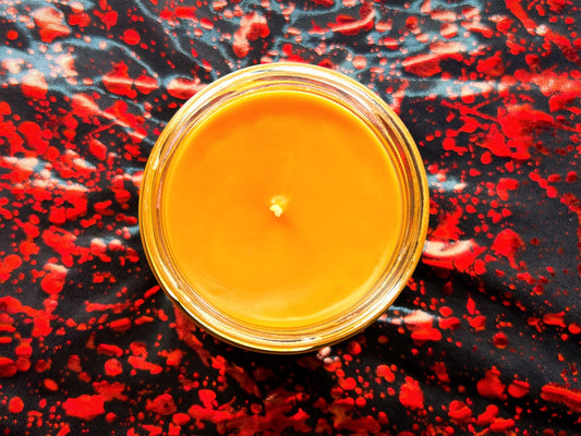 Top-down view of Check Your Candy candle's orange wax surface