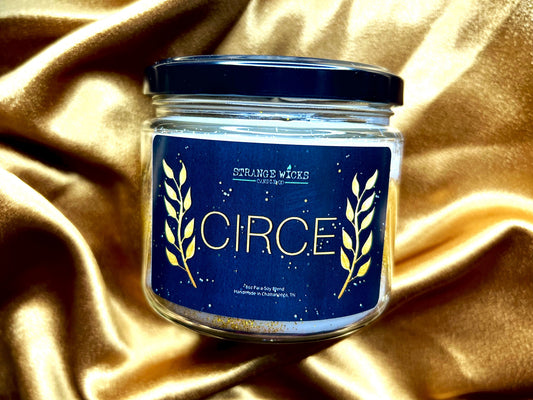 Close-up of Circe candle label with gold wheat-branch art on navy