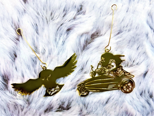 Close-up of gold owl and flying-motorbike charms from the candle carousel