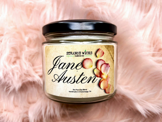 Jane Austen candle in glass jar with script rose-petal label on pink fur