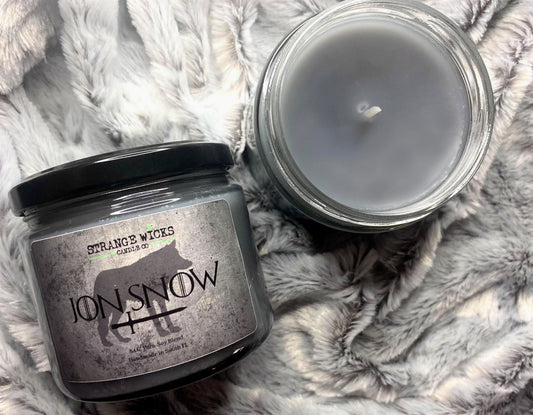 Jon Snow candle beside its open jar showing smooth black wax