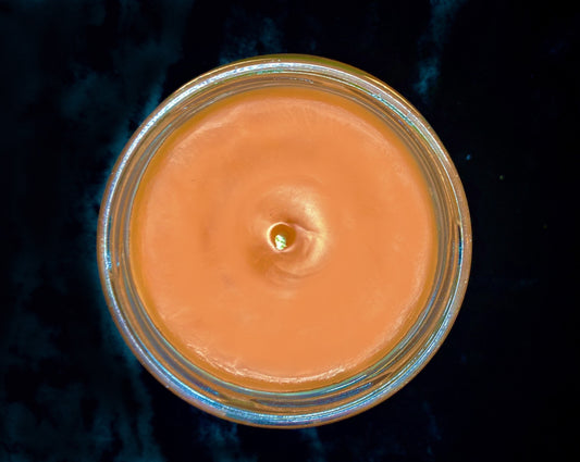 Top-down view of the open Gallavich candle showing orange wax