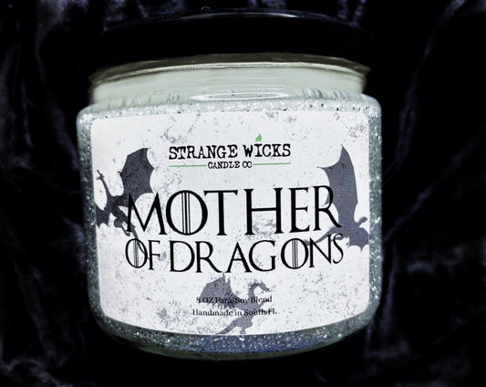 Close-up of Mother of Dragons Candle with dragon label, black lid and glitter jar
