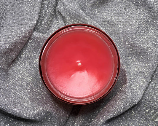Back view of The Pink Palace candle showing pink wax and button-topped lid