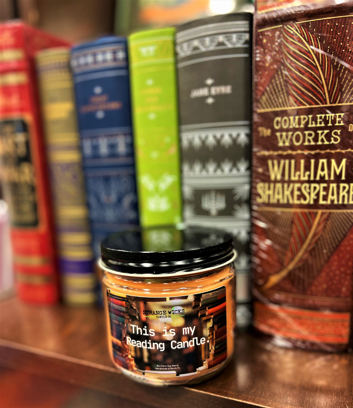 This is My Reading Candle on a bookshelf beside Shakespeare's Complete Works