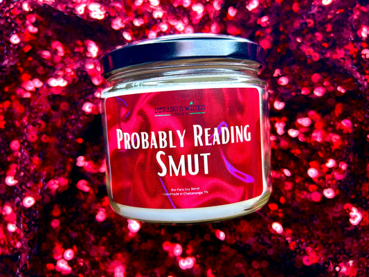 Probably Reading Smut candle with black lid on red sequin fabric