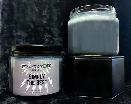 Simply the Best candle next to an unlabeled jar on a black gift box