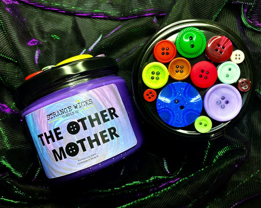 Coraline Candle Collection – The Other Mother candle beside its button-covered lid