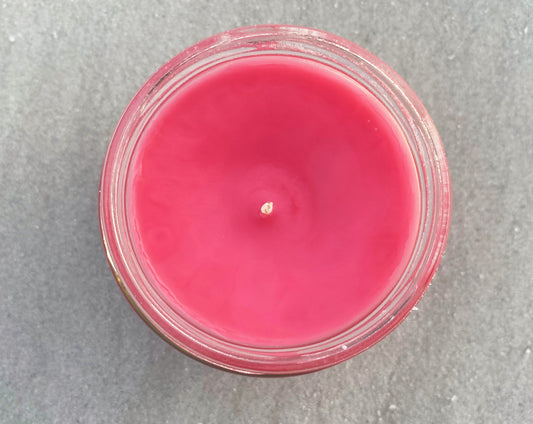 Top-down view of the Watermelon Sugar candle's pink wax and centered wick