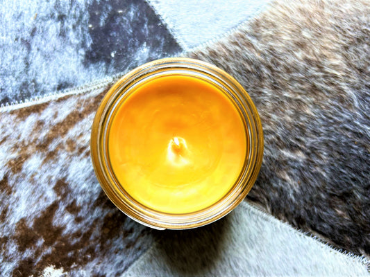 Top-down view of Yellowstone Candle showing golden-yellow wax and wick